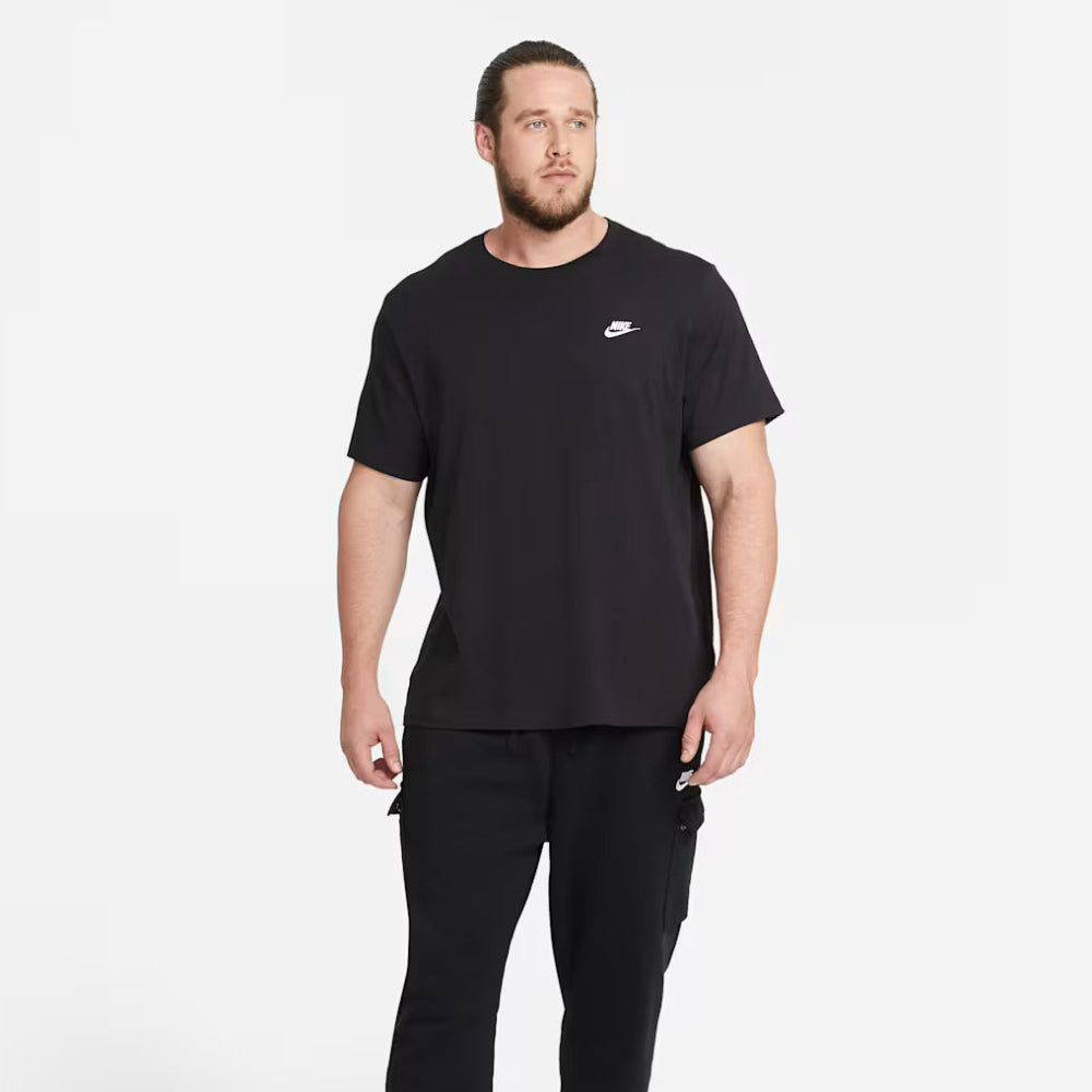 Man wearing a black Nike t-shirt and jogger pants on a white background