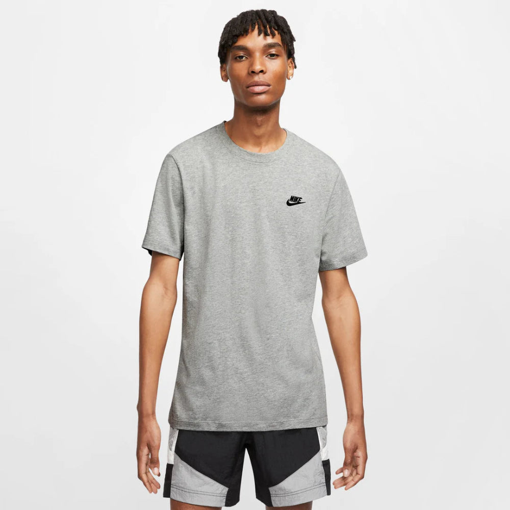 Man wearing a gray t-shirt with a Nike logo on a white background