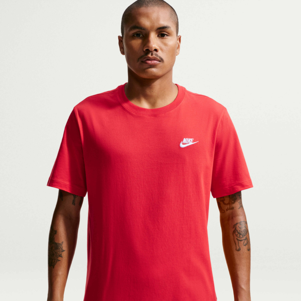Man wearing a red Nike t-shirt on a plain background