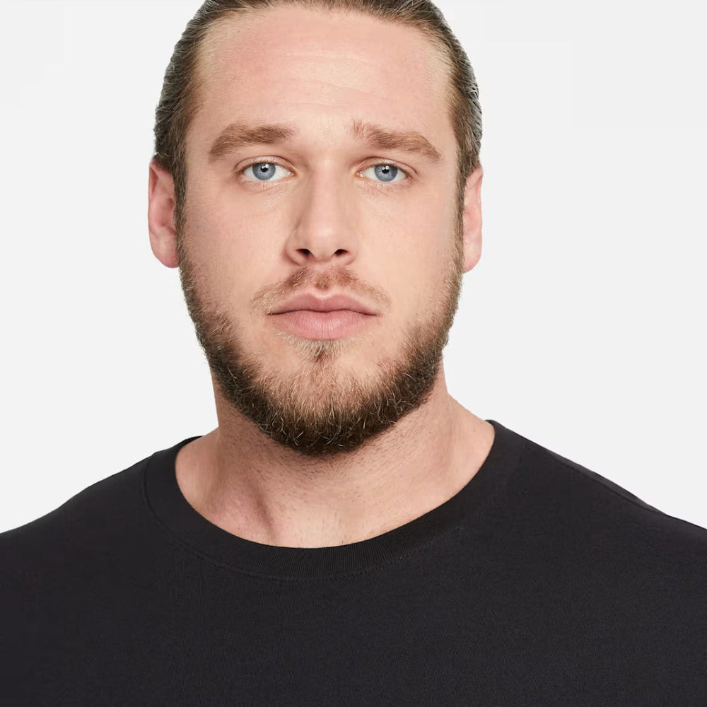Man wearing a black Nike t-shirt against a white background