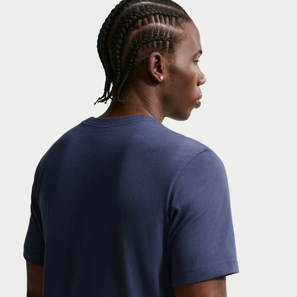 Person wearing a navy blue t-shirt on a plain background